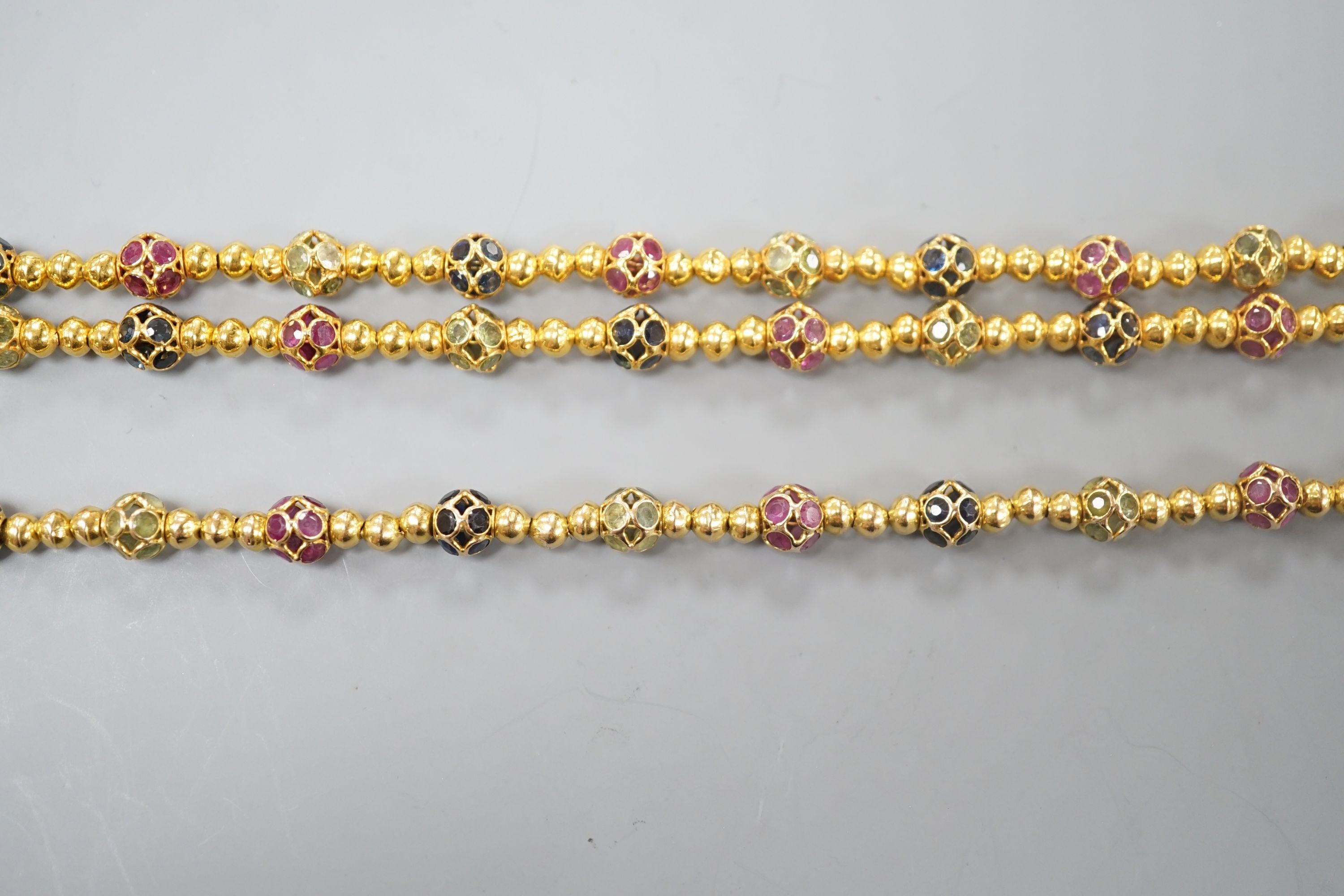 A modern Thai yellow metal and gem set spherical link necklace, 72cm and a similar bracelet stamped 585, 17.5cm, gross weight 35.4 grams.